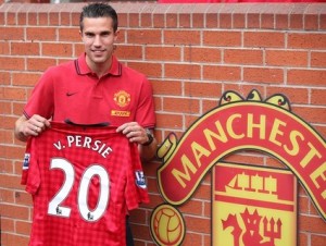 Manchester United's new signing Robin Van Persie poses with his shirt during a photocall at Old Trafford, Manchester.